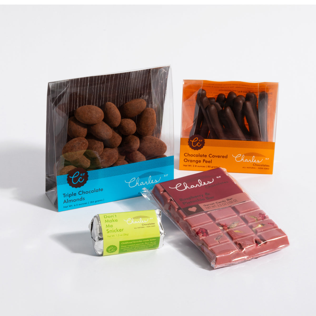 Charles Chocolates Starter Pack, four items: Triple Chocolate Almonds, chocolate covered orange peel, Don't Make Me Snicker mini bar, ruby bar