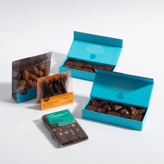 Charles Chocolates Starter Pack, nuts, orange peel and a bar with two open signature boxes