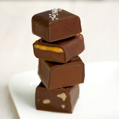 A stack of John Kelly Chocolates truffle fudge squares with sea salt