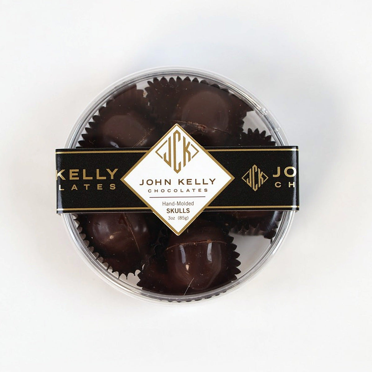 Five dark chocolate skulls in the clear gift box, top view