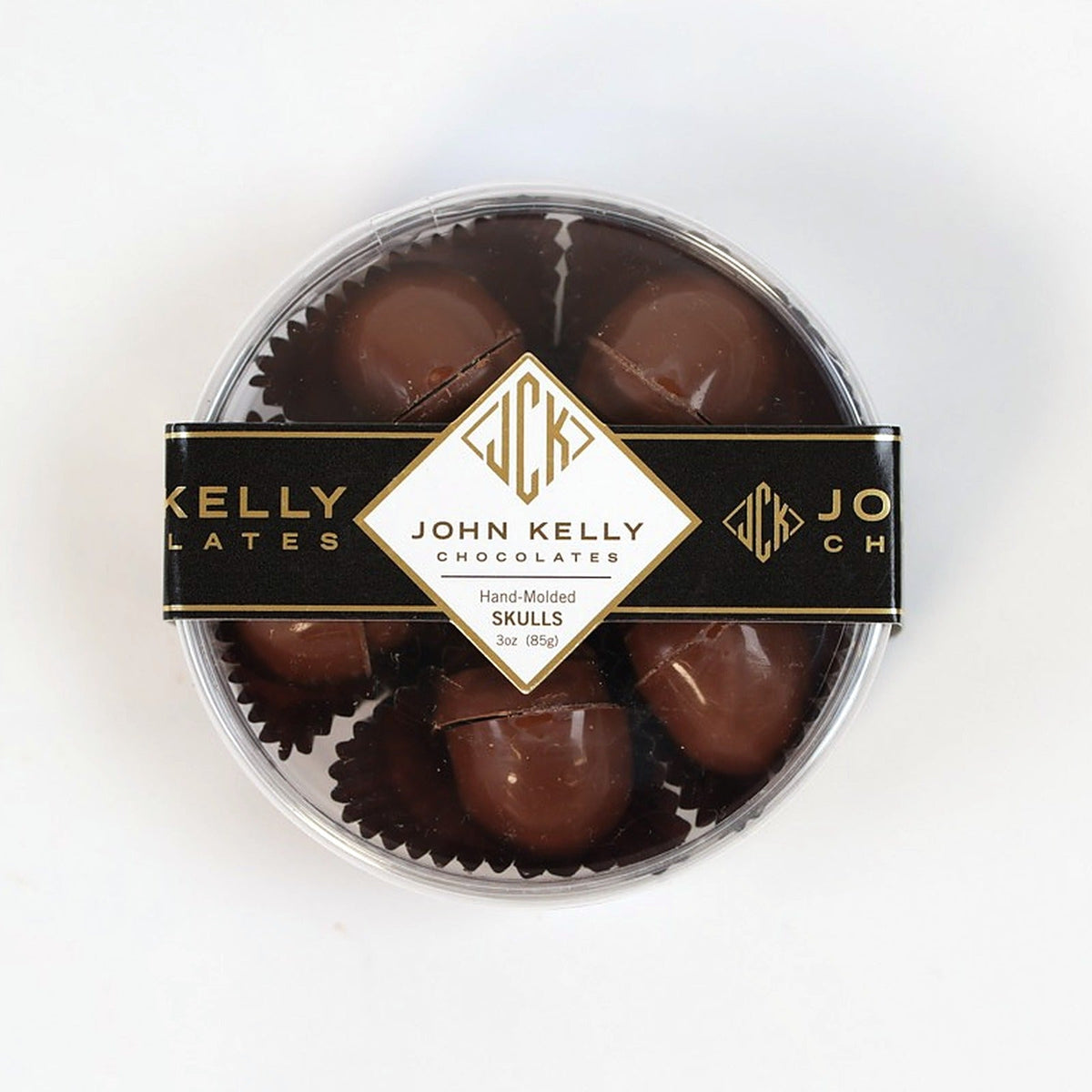 Five milk chocolate skulls in the clear gift box, top view