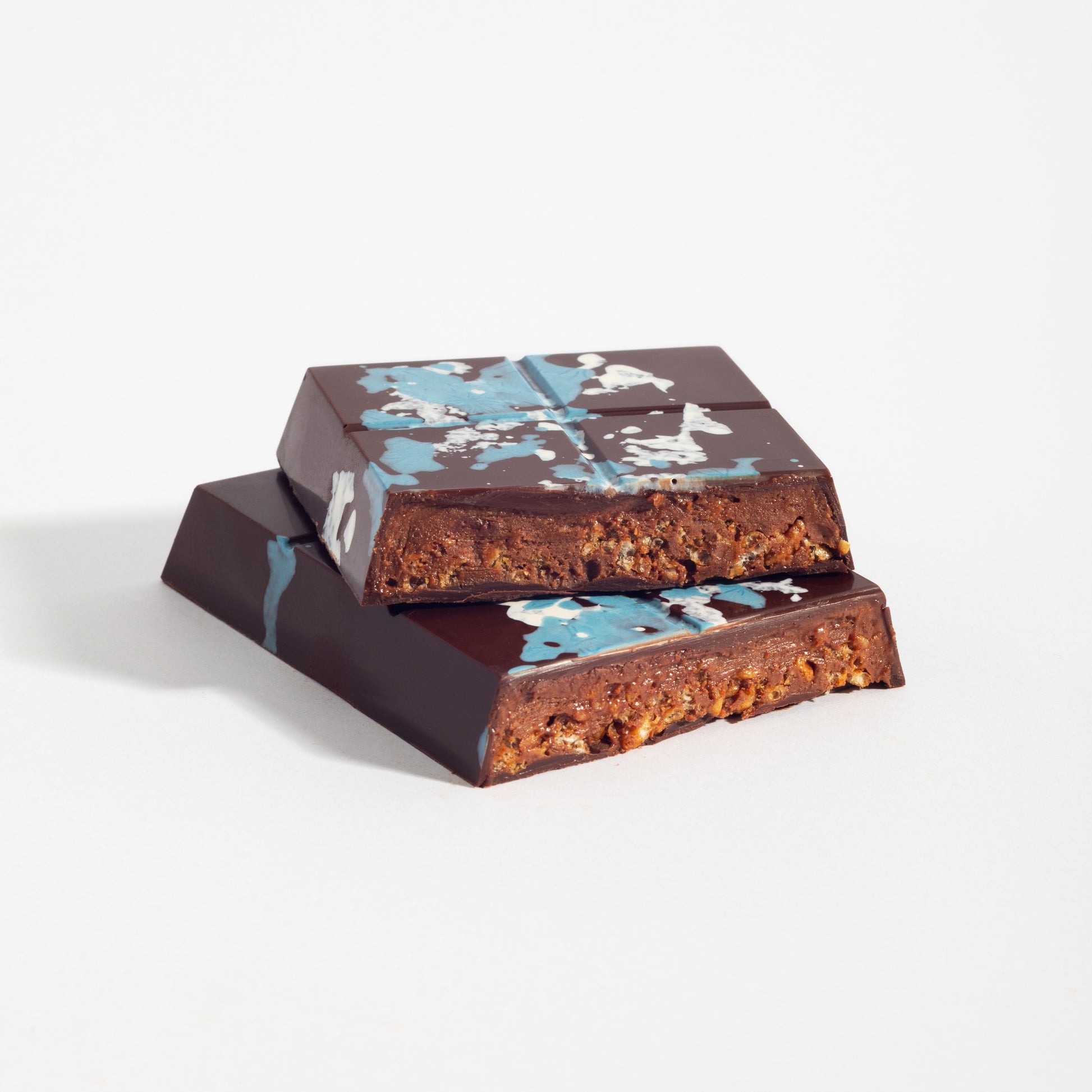 Stacked squares of Almond French Praline Crunch Bar showing the crisped praline filling