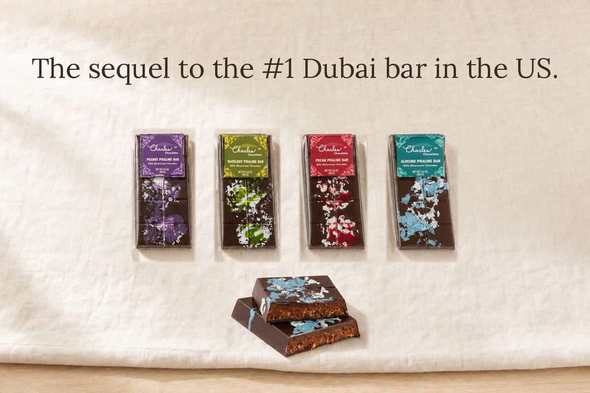The sequel to the #1 Dubai bar in the US. The four Praline Crunch bars, Peanut, Hazelnut, Pecan and Almond, with a cut Almond Praline bar showing the crunch inside