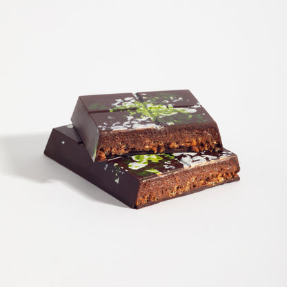 Stacked squares of Hazelnut French Praline Crunch Bar showing the crisped praline filling
