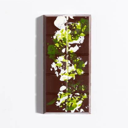Unwrapped Hazelnut French Praline Crunch Bar with green cocoa butter splatter on dark chocolate