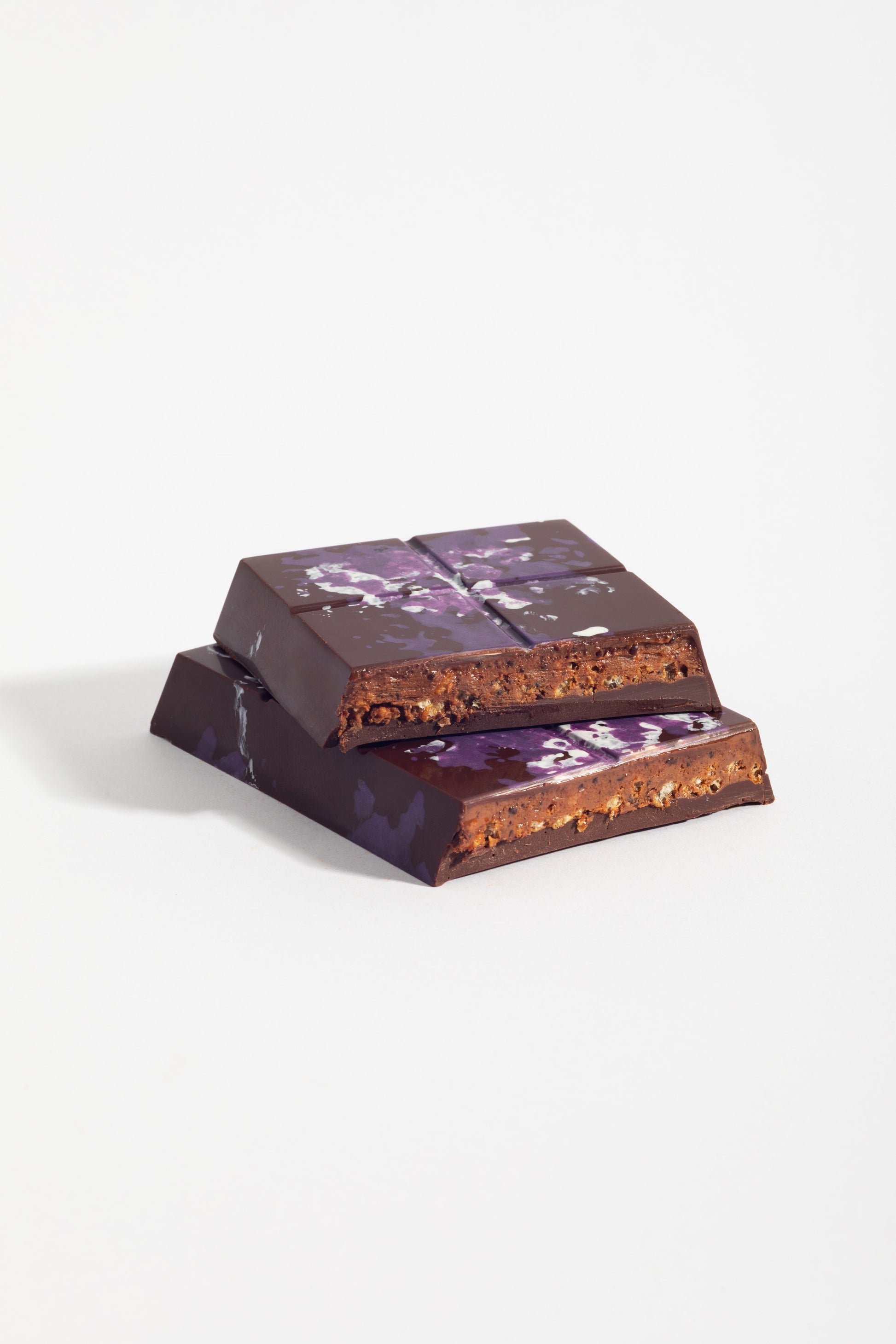 Stacked squares of Peanut French Praline Crunch Bar showing the crisped praline filling