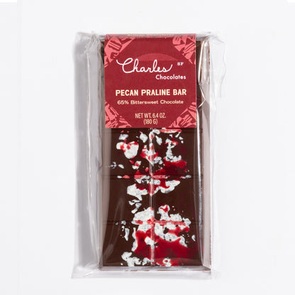 Pecan French Praline Crunch Bar in its raspberry botanical wrapper by Charles Chocolates